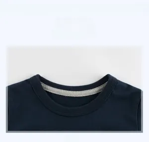 Detail of navy blue crew neck t-shirt showing high-quality stitching and collar binding