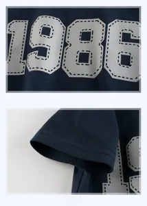 Detail of 1986 white number print and double-stitched hem on navy boys cotton T-shirt