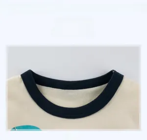 Detail view of cotton t-shirt with navy ribbed neckline and cream knit fabric