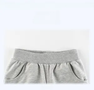 Detail view of the gray cotton knit shorts showing the elastic waistband and side pockets