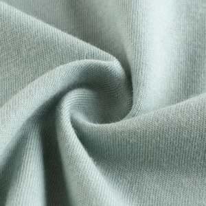 Close-up of light blue knitted cotton fabric showing fine texture for kids' t-shirts