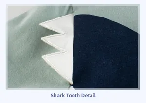 Détail de broderie en dents de requin sur tissu tricoté vert pour t-shirt enfant