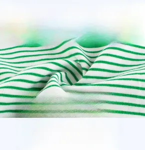 Close-up of soft green and white striped knit fabric for baby vests and tops