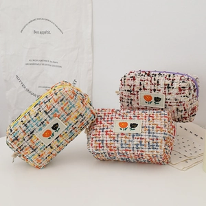 Tweed cosmetic bags in three colors with floral patches and spacious zip design