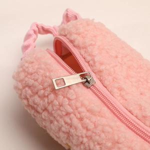 Detailed close-up of pink sherpa fleece stationery bag with metallic zipper and corduroy handle