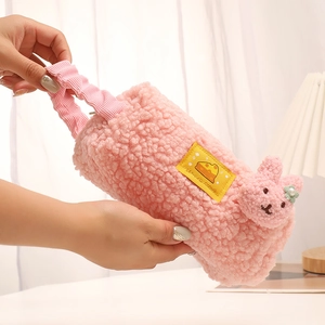 Close-up of pink sherpa pencil case with cute rabbit detail and soft corduroy handle