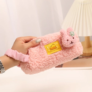 Pink sherpa pencil case with cute rabbit patch and velvet handle, hand-held detail view