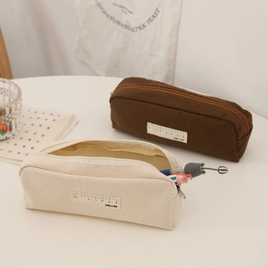 Minimalist canvas pencil cases in beige and brown colors with ruler label design