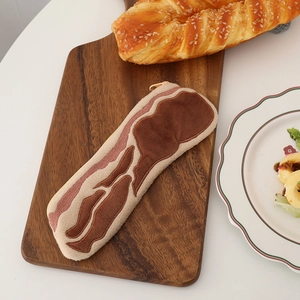 Detailed view of plush pencil case with realistic bacon texture on wooden board