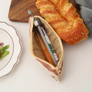 Close-up of plush bacon-style pencil case featuring soft fleece fabric and inner stationery