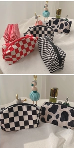 Detail of velvet checkered cosmetic bag with textured seersucker fabric and smooth zipper