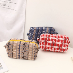 Three assorted knitted cosmetic bags with zipper closure and ethnic geometric patterns