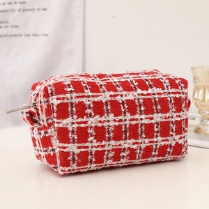 Close-up of red and white checkered knit makeup bag with metal zipper and pull handle