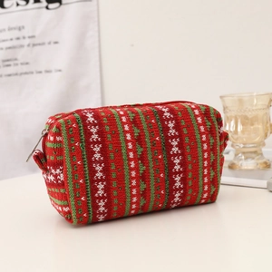 Detail of red and green knitted Christmas pouch with silver zipper and soft texture
