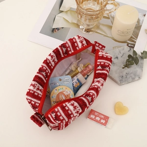 Detailed close-up of red and white jacquard knit pouch with a red zipper closure
