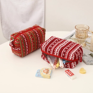 Close-up of festive red knit pencil case with Fair Isle pattern and metal zipper detail