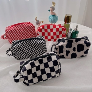 Five assorted velvet checkerboard cosmetic bags with sturdy handles and metal zippers