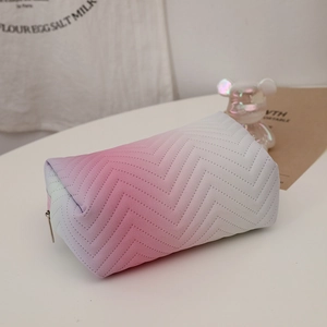 Detailed view of pink gradient PU leather cosmetic bag with soft wavy quilted texture