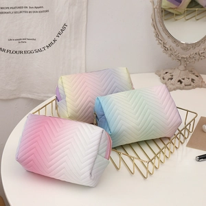 Three-piece set of gradient PU leather makeup bags with V-quilted texture in a gold basket