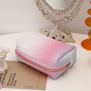 Macro detail of gradient PU leather makeup bag with elegant wave stitching and metal zipper