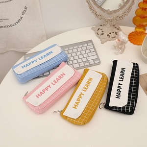 Detail of four high-capacity double-layer canvas pencil cases in assorted pastel colors