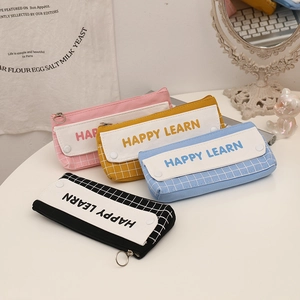 Detail of grid pattern canvas pencil cases with HAPPY LEARN print and metal zipper pullers
