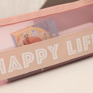 Macro detail of pink mesh pencil case showing fabric texture and HAPPY LIFE leather label