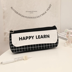 Detail of minimalist black and white checkered pencil case with Happy Learn text