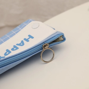 Macro detail of a light blue checkered pencil case with zipper and metal ring puller