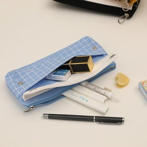 Detail of light blue checkered pencil case showing spacious multi-layer storage capacity
