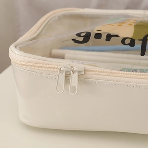 Detail of clear giraffe cosmetic bag with white leather trim and dual metal zippers