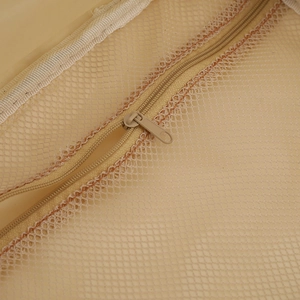 Detail of fine beige mesh fabric and durable metal zipper on a large cosmetic bag