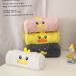 Close-up of cute plush duck pencil cases in pink, yellow, grey and white colors