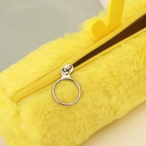 Close-up of vibrant yellow plush pencil case with large silver ring zipper detail