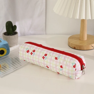 Close-up of quilted floral pencil case with red zipper and soft cotton texture