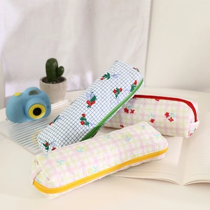 Detailed view of three quilted floral pencil cases in blue, pink and multicolor patterns