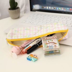 Pink plaid fabric pencil case with stationery, mini fan and yellow zipper detail