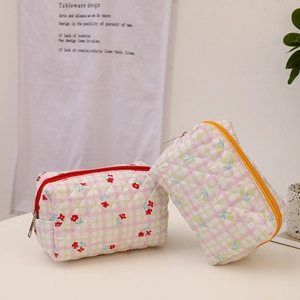 Quilted floral makeup bag with cream bear pattern and secure zipper for travel storage