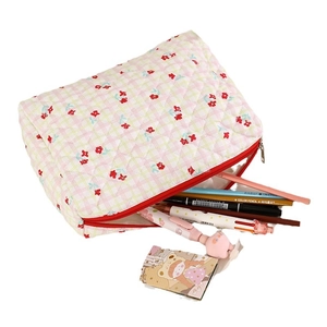 Quilted floral makeup bag with red flower patterns and secure zipper closure