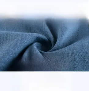 Macro detail of dark grey-blue knit fabric showing soft, breathable texture for baby t-shirts