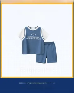 Flat lay of blue two-piece summer set for boys featuring smiley face tee and shorts