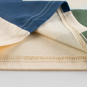 Kids' short-sleeve T-shirt featuring a blue and beige color-block design with dual stitching
