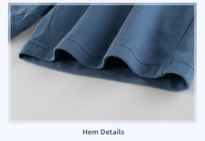 Close-up of double-stitched hem on blue cotton knit trousers showing fine sewing detail