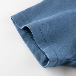 Close-up of dual-needle stitching on the cuff of a soft cotton blue kids' t-shirt