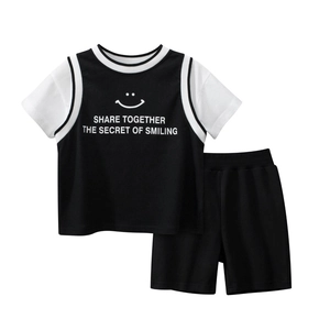Two-piece boys summer set with smile graphic t-shirt and black shorts on white background