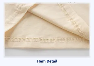 Gros plan détaillé des coutures de l'ourlet et du tissu en coton doux de ce t-shirt beige