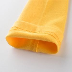 Close-up of yellow long sleeve cotton t-shirt cuff with durable double stitching
