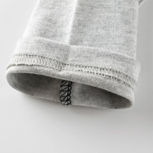 Detail of grey knit long-sleeve tee showing durable stitching and high-quality cotton fabric