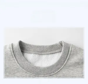 Close-up of the grey sweatshirt neckline featuring soft white fleece lining and ribbed trim