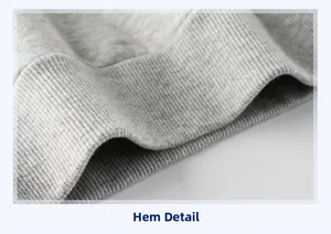 Macro view of light grey ribbed knit hem on children's cotton blend sweatshirt